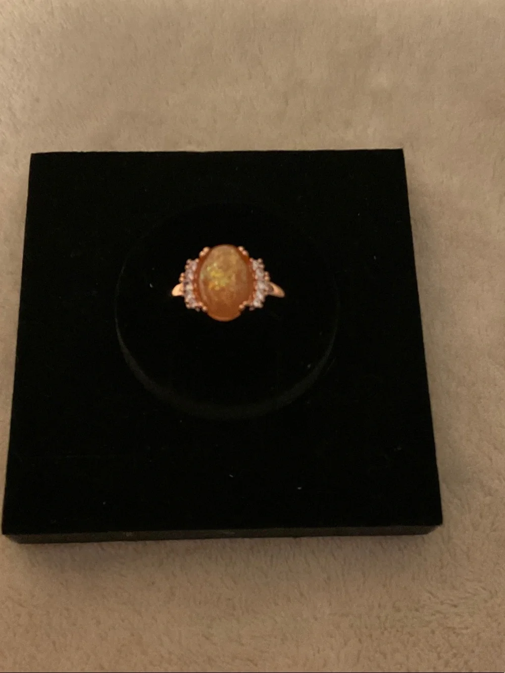 Gold-Tone Ring with Orange Opal Center and Clear Accent Stones